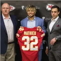  ?? TAMMY LJUNGBLAD / THE KANSAS CITY STAR ?? Chiefs GM Brett Veach (right) and coach Andy Reid made signing safety Tyrann Mathieu a priority in the offseason. Mathieu and other acquisitio­ns have solidified a defense that came up short in the AFC title game last season.