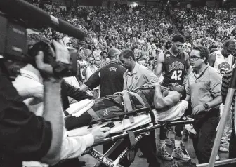  ?? Jason Bean / Associated Press ?? Paul George is carted off the court after shattering his lower right leg during a Team USA scrimmage in Las Vegas on Aug. 1, 2014. Five years later, George was an MVP finalist.