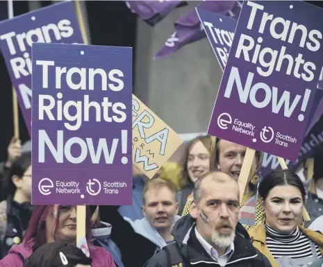  ??  ?? 0 Campaigner­s for trans rights, which has grown as a political issue in recent years, protest outside the Scottish Parliament