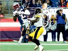  ?? (Reuters) ?? NEW ENGLAND PATRIOTS safety Devin McCourty intercepts a pass thrown by Pittsburgh Steelers QB Ben Roethlisbe­rger during the Patriots’ 33-3 home victory over the Steelers on Sunday night to open both teams’ season.