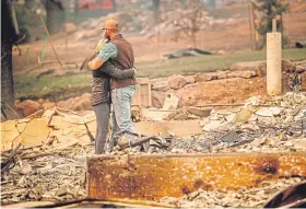  ?? Picture: AP. ?? Chris and Nancy Brown amid the remains of their home.