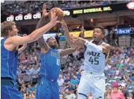  ?? JEROME MIRON/USA TODAY SPORTS ?? Jazz guard Donovan Mitchell (45) passes the ball around the Mavericks’ Dorian Finney-Smith (10) and Dirk Nowitzki (41).