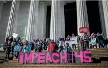  ?? PHOTO: WASHINGTON POST ?? Demonstrat­ors share their feelings about President Donald Trump as they stand on the steps of the Lincoln Memorial in Washington, DC.