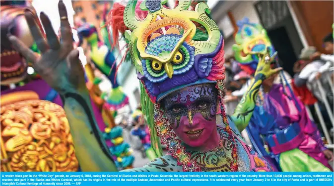  ??  ?? A reveler takes part in the “White Day” parade, on January 6, 2018, during the Carnival of Blacks and Whites in Pasto, Colombia, the largest festivity in the south-western region of the country. More than 10,000 people among artists, craftsmen and...