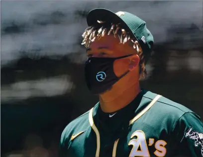  ?? ANDA CHU — BAY AREA NEWS GROUP, FILE ?? Players such as A’s pitcher Frankie Montas, above, will have to get used to wearing masks before the season starts.