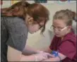  ?? ERIC BONZAR — THE MORNING JOURNAL ?? Sixteen-year-old Heather Wardrop, of Lorain, practices drawing blood of her fellow Life Skills High School classmate Ashley Brooks, 20, of Elyria, Oct. 24.