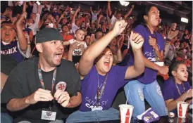  ?? ROB SCHUMACHER/AZCENTRAL SPORTS ?? Suns fans Gerry Chaffin (left) and Andrew Chaffin (middle) react to Phoenix selecting Kansas’ Josh Jackson in the first round of the NBA draft on Thursday at Talking Stick Resort Arena.