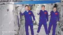  ?? XU BU / FOR CHINA DAILY ?? A screenshot captured at the Beijing Aerospace Control Center shows Shenzhou XIII mission crew Zhai Zhigang (center), Wang Yaping (right) and Ye Guangfu greet people across China after they enter the Tianhe core module of the Tiangong space station on Oct 16.