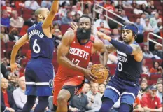  ?? Michael Wyke / Associated Press ?? Houston Rockets guard James Harden drives to the basket between Minnesota Timberwolv­es guard Jordans McLaughlin ( 6) and D’Angelo Russell during the second half of a game in March.