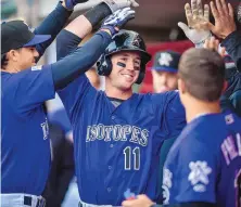  ?? ROBERTO E. ROSALES/JOURNAL ?? Drew Weeks (11) is congratula­ted by teammates after hitting a home run during the Isotopes’ loss to Salt Lake Friday.