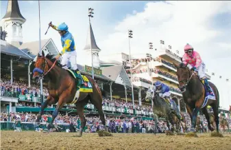  ?? Mark Cornelison / Lexington Herald-Leader ?? American Pharoah, the 5-to-2 favorite with jockey Victor Espinoza aboard, surges past Firing Line to win the 141st running of the Kentucky Derby at Churchill Downs in Louisville, Ky.