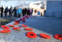  ??  ?? Poppies litter the Cenotaph near City Hall on Saturday during Remembranc­e Day services.