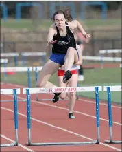  ?? Photo by Becky Polaski ?? Maura Caskey leads the way in the girls’ 300 meter hurdles. Caskey won the event in 52.39 seconds.