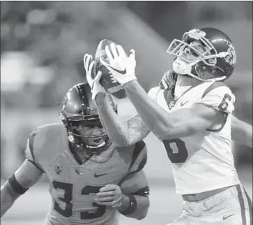  ?? Timothy J. Gonzalez Associated Press ?? MICHAEL PITTMAN JR. can’t hold on to a pass while being defended by Oregon State’s Jalen Moore on Saturday. Pittman left with a shoulder injury, but freshman Devon Williams came in and scored a touchdown.