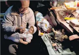  ?? JUAN KARITA/AP ?? Artist Roberto Ramos retouches a plaster doll of the infant Jesus this month at his workshop in La Paz, Bolivia. “Without baby Jesus there is no Christmas,” says a client.