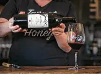  ?? Josie Norris / Staff photograph­er ?? Erin Shields pours a glass of tannat at the Bending Branch Winery in Comfort. Hill Country wineries have exploded in popularity in the past decade, with permits up 625 percent.