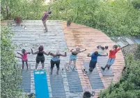  ??  ?? Indigo Monae leads a yoga class at the Yoga Gardens space in the Lawndale neighbourh­ood of Chicago, Ill.