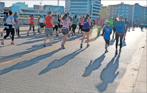  ?? PHOTOS] [ANDREA NOALL/DISPATCH ?? Participan­ts take off in the Run Like a Girl race Downtown on Saturday. It raised money for the American Heart Associatio­n.