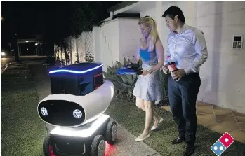  ?? BMI/AFP/GETTY IMAGES ?? Fast food giant Domino’s has developed a robotic cart named DRU, which stands for Domino’s Robotic Unit, to deliver its offerings in Australia. So far, it only has one, but hopes to expand to other countries.