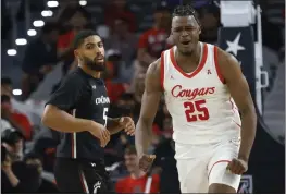  ?? RON JENKINS — THE ASSOCIATED PRESS ?? Houston forward Jarace Walker (25) reacts after a dunk as Cincinnati guard David DeJulius (5) looks on during the second half in the semifinals of the American Athletic Conference Tournament on Saturday in Fort Worth, Texas.