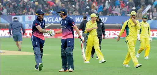  ?? AP ?? England’s Ben stokes (left) is congratula­ted by Jos Buttler as the players leave the field due to rain in Edgbaston on saturday. —