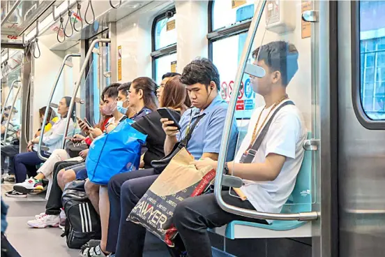  ?? ?? PASSENGERS of the LRT-2 contemplat­e on things as they ride to their respective destinatio­ns on a Friday morning.