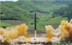  ?? — AFP ?? This picture taken and released yesterday shows the test-fire of the interconti­nental ballistic missile Hwasong-14 at an undisclose­d location in North Korea.