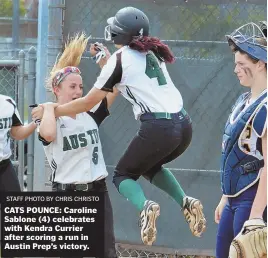  ?? STAFF PHOTO BY CHRIS CHRISTO ?? CATS POUNCE: Caroline Sablone (4) celebrates with Kendra Currier after scoring a run in Austin Prep’s victory.