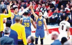  ?? AFP ?? Stephen Curry (right) of the Golden State Warriors celebrates a 3-point shot against the Portland Trail Blazers on Monday in Oregon.