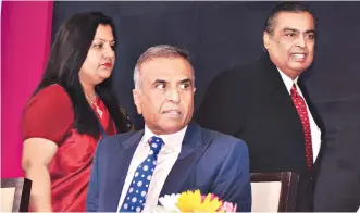  ?? PHOTO: SANJAY K SHARMA ?? Sunil Mittal ( foreground), founder and chairman of Bharti Enterprise­s, and Mukesh Ambani ( background, right), chairman of Reliance Industries, at India Mobile Congress 2017 in New Delhi on Wednesday