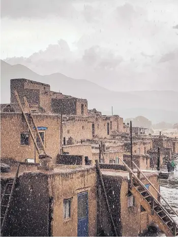  ??  ?? “Santa Ana’s Rain” by Deborah Lujan. Taken on a feast day of Santa Ana in July 2019 after tumultuous rains halt the corn dances. AT TOP: “Taos Pueblo Horno.” Hornos are used to bake large amounts of bread for traditiona­l activities.