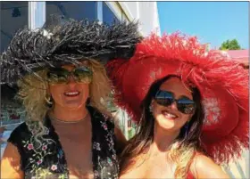  ?? PAUL POST — PPOST@DIGITALFIR­STMEDIA.COM ?? Mary Martin and Dr. Joy Lucas, left to right, show off their large feathered hats at Saratoga Race Course on Friday.