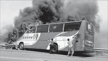  ?? Bao Liao Commune ?? PEOPLE TRY to break the windows of a burning tourist bus in Taiwan last month. The disaster killed 24 Chinese tourists and drew an enraged reaction from China — which might not have happened a year ago.