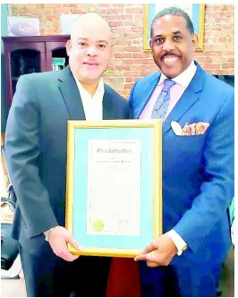  ?? PHOTO BY ANTHONY TURNER ?? New York State Senator Kevin S. Parker (right) of the 21st Senatorial District in Brooklyn issues a New York state proclamati­on for Jamaican reggae icon Peter Tosh for this year’s observance of 4/20. Accepting the award is Brian Latture, executive manager of the Peter Tosh Estate. The presentati­on was made at the senator’s office in Brooklyn, New York.