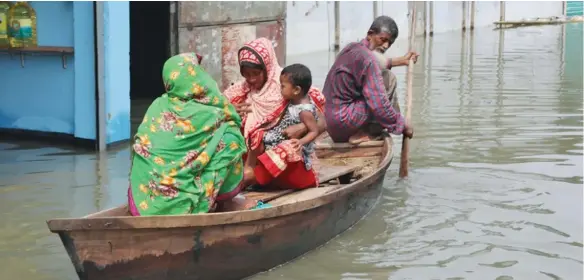  ?? Photo: Xinhua ?? People take a boat in a flooded area in Munshiganj on the outskirts of Dhaka, capital of Bangladesh, on July 27, 2020.