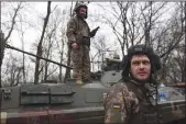  ?? ANATOLII STEPANOV/AFP VIA GETTY IMAGES ?? Ukrainian soldiers stand next to their armoured personnel carrier, not far from the front line with Russian troops in Izyum district, Kharkiv region, Ukraine on Monday.