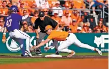  ?? TENNESSEE ATHLETICS PHOTO ?? Tennessee third baseman Billy Amick applies the tag on LSU’s Tommy White during Saturday evening’s 3-1 victory by the Volunteers.