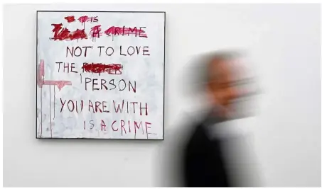  ?? — Reuters ?? A visitor walks past No Love during the launch of A Fortnight Of Tears, an exhibition of new works by Emin at White Cube gallery in London.