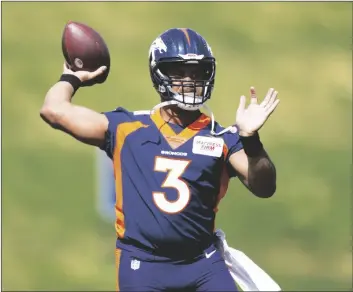  ?? DAVID ZALUBOWSKI/AP ?? Denver Broncos quarterbac­k Russell Wilson takes part in drills at the NFL football team’s voluntary minicamp on April 27 at the team’s headquarte­rs in Englewood, Colo.