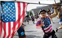  ?? BRANDEN CAMP / FOR ATLANTA JOURNAL-CONSTITUTI­ON 2017 ?? Patriots abound at the AJC Peachtree Road Race, like this one on Peachtree Street last July 4th.