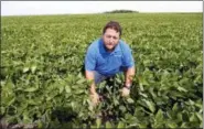  ?? JIM MONE — THE ASSOCIATED PRESS ?? Soybean farmer Michael Petefish poses in his soybean field at his farm near Claremont in southern Minnesota. American farmers have put the brakes on unnecessar­y spending as the U.S.-China trade war escalates, hoping the two countries work out their difference­s before the full impact of China’s retaliator­y tariffs hits American soybean and pork producers.