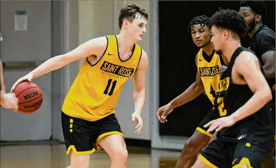  ?? Photos by Will Waldron / Times Union ?? Saint Rose College freshman Shane O’dell, left, works with teammates during practice for the men’s basketball team. O’dell, of Schalmont, said he expects a big turnout for the exhibition match between the Golden Knights and Siena.