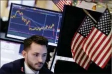  ?? RICHARD DREW — THE ASSOCIATED PRESS ?? Specialist Matthew Greiner works at a post on the floor of the New York Stock Exchange, Monday.