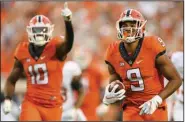  ?? (AP/Brody Schmidt) ?? Oklahoma State wide receiver Bryson Green (right) scores on a 41-yard touchdown pass from Spencer Sanders in the fourth quarter Saturday against Texas in Stillwater, Okla., as teammate Rashod Owens celebrates.