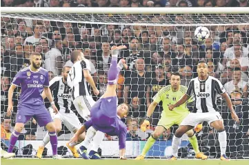  ??  ?? Juventus’ Italian goalkeeper Gianluigi Buffon (second right) and Juventus’ Brazilian defender Alex Sandro (right) watch as Real Madrid’s Portuguese striker Cristiano Ronaldo’s shot goes wide during the UEFA Champions League final football match between...