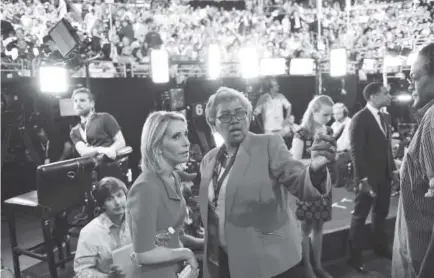  ?? Jabin Botsford, The Washington Post ?? Donna Brazile, center, talks with CNN correspond­ent Dana Bash at the Democratic National Convention in Philadelph­ia on July 25, 2016. Brazile writes that she reluctantl­y took over as DNC chairwoman that month.