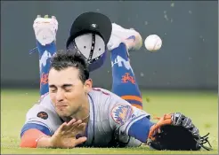  ??  ?? WIPEOUT: Michael Conforto can’t come up with a ball in the eighth inning of the Mets’ 7-6 loss to the Braves on Tuesday.