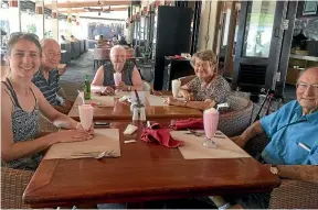  ??  ?? Enjoying cold drinks in Bali. Debra, left, says planning the travel and accommodat­ion was more time-consuming than she had thought, but "well worth the effort to get right".