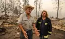  ?? Photograph: David McNew/AFP/Getty Images ?? Gary Rainey, a rancher, and the volunteer fire department chief, Janet Jones, talk to a reporter at the ruins of the century-old Klamath River Community Hall, which was destroyed by the McKinney fire.