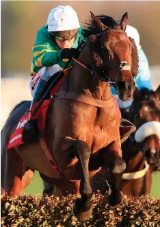  ??  ?? Unowhatime­anharry, ridden by Barry Geraghty, on the way to winning The Ladbrokes Long Distance Hurdle Race at Newbury yesterday